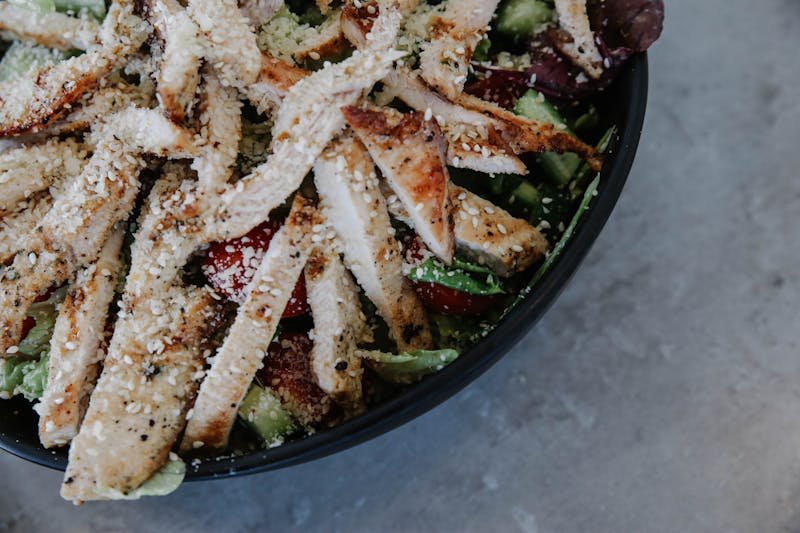 Grilled chicken salad with avocado and greens